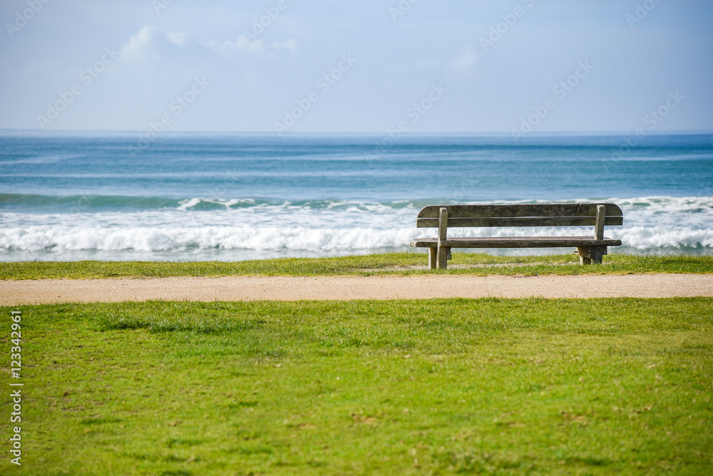 Wood bench near beach and sea