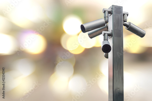 Closeup CCTV camera on colorful lighting background.