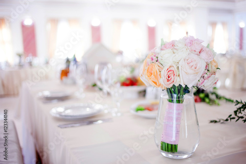 Wedding floristry. Beautiful lush bouquet on the table in restaurant © Ulia Koltyrina