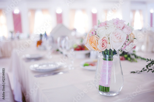 Wedding floristry. Beautiful lush bouquet on the table in restaurant