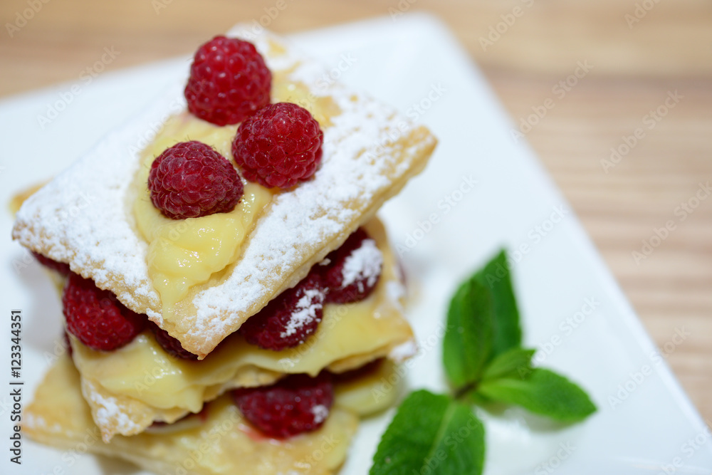 Puff pastry with mint leaves and raspberries, top view