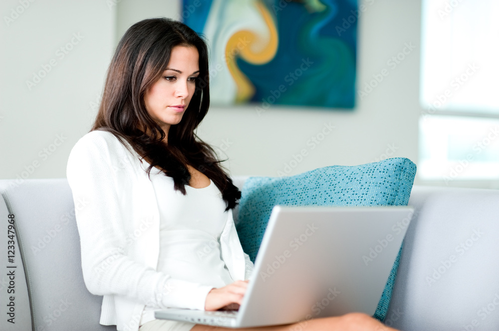 Young Woman with Laptop Computer at Home Young Woman with Laptop Computer at Home