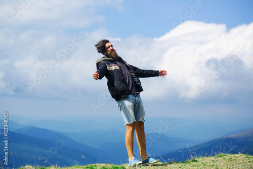 Man hipster on mountain top