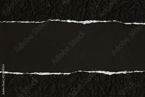 Ripped crumpled black paper with space