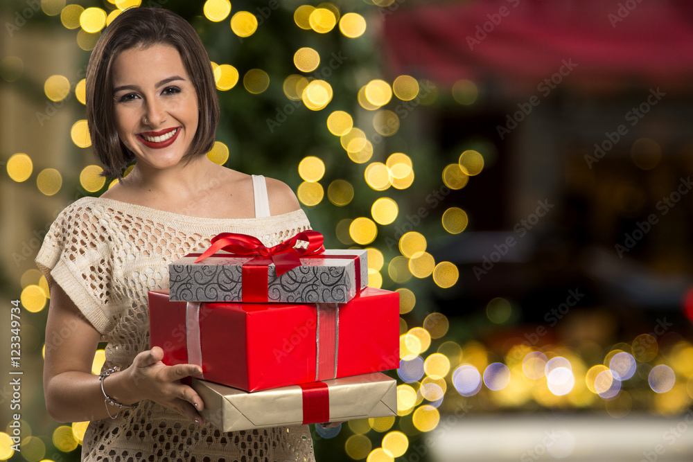 Christmas woman portrait holding christmas gift. Smiling happy Christmas woman portrait holding christmas gift. Smiling happy