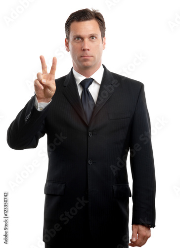 Businessman giving peace hand sign on white