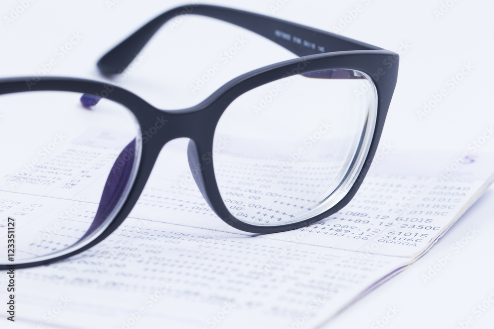 Finance Concepts, glasses with passbook as background Finance Concepts, glasses with passbook as background