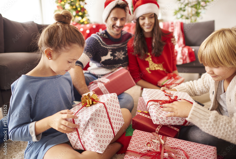 Happy family start opening Christmas presents