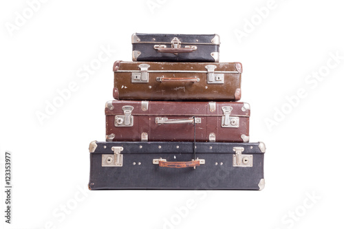 Stack of old vintage suitcases isolated on white