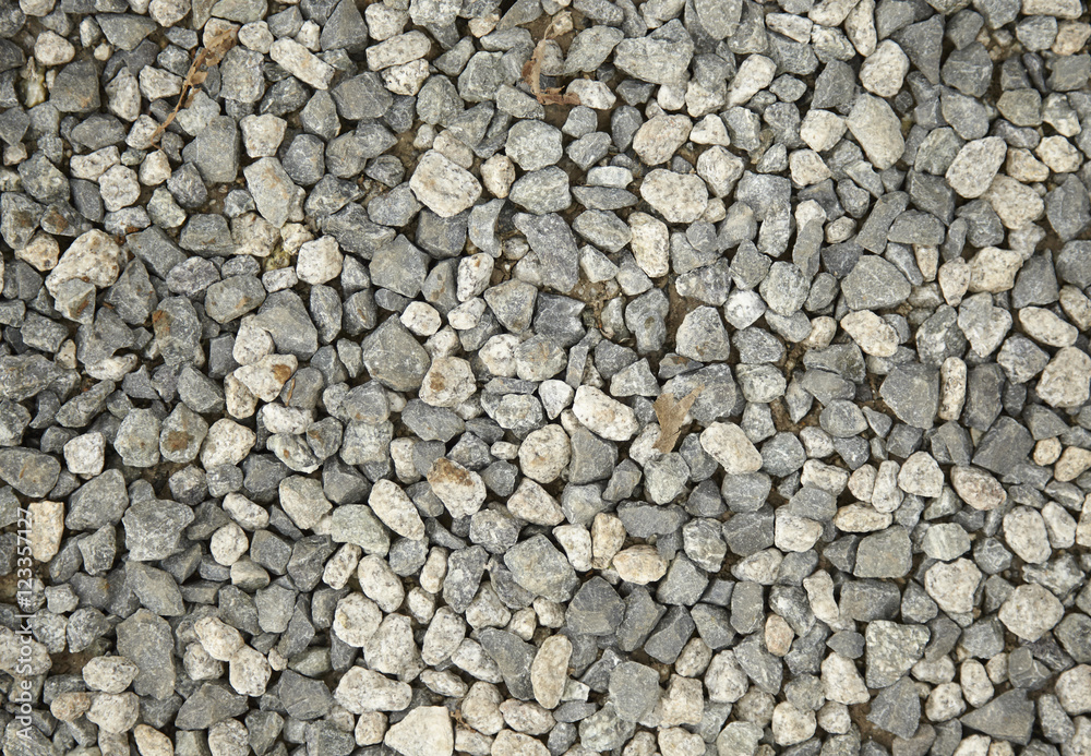 A full page of grey gravel driveway background texture A full page of grey gravel driveway background texture