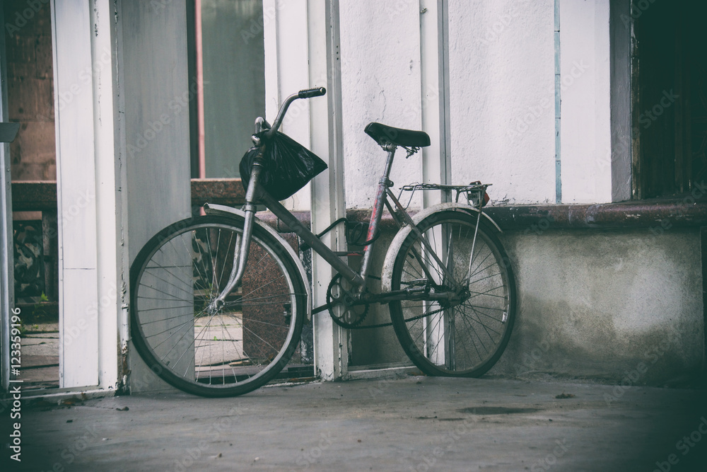 old bicycle standing on the street, from the wheel spokes on a b old bicycle standing on the street, from the wheel spokes on a b