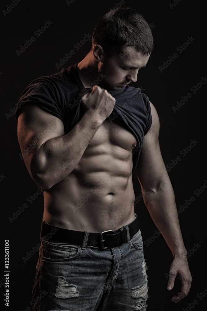 Muscular man with shirt on shoulder