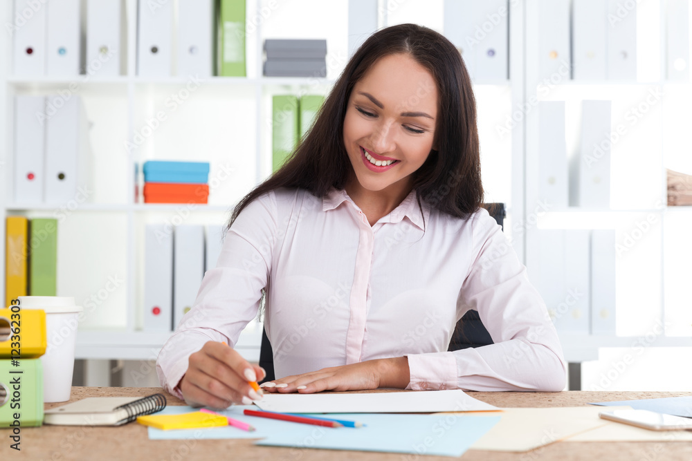 Smiling designer sketching Smiling designer sketching