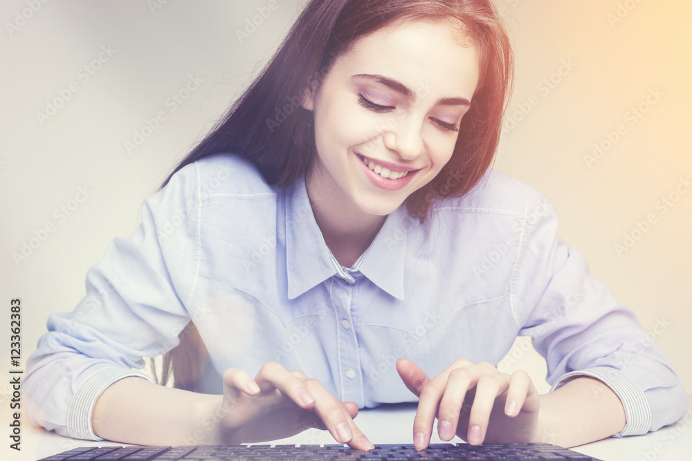 Gorgeous smiling woman using the keypad Gorgeous smiling woman using the keypad