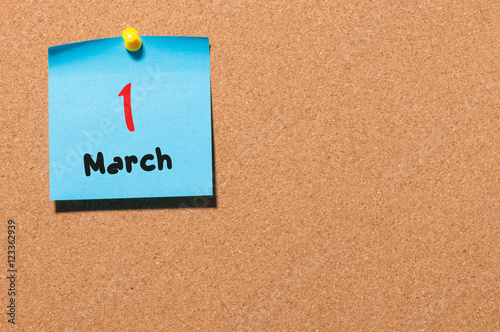 March 1st. Day 1 of month, calendar on cork notice board background. Spring time, empty space for text