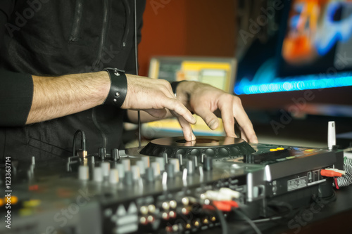 Hands of a DJ playing music at a party © 621513