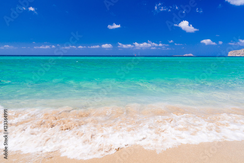 Fototapeta Naklejka Na Ścianę i Meble -  Perfect tuquoise waters with waves rolling on a sandy beach of Falassarna in Crete, Grece