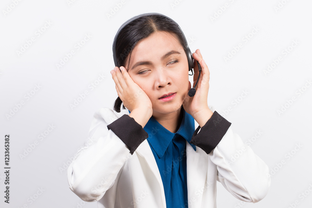 Operator or businesswoman in headset and she has headache Operator or businesswoman in headset and she has headache
