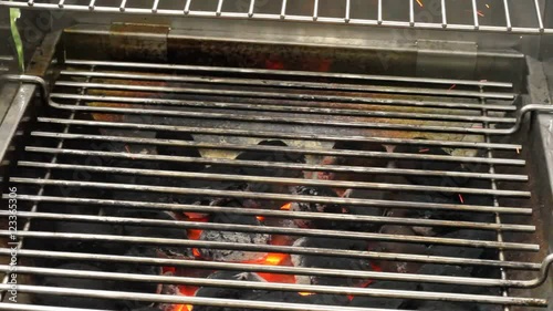 Heating a charcoal grill for a barbecue photo