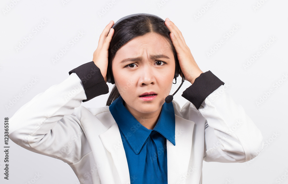 Operator or businesswoman in headset and she has headache