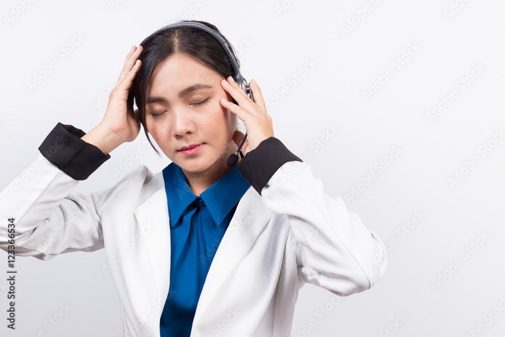 Operator or businesswoman in headset and she has headache Operator or businesswoman in headset and she has headache