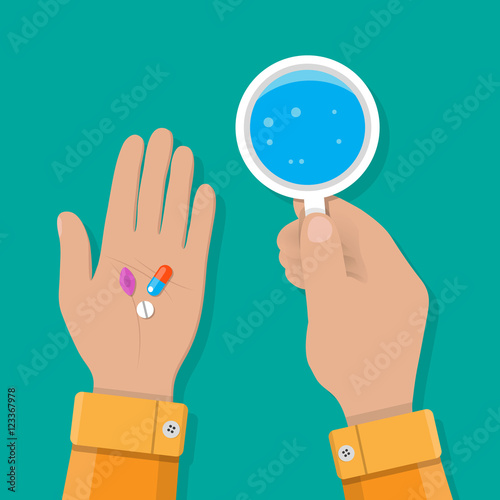 hand holds glass of water and pills