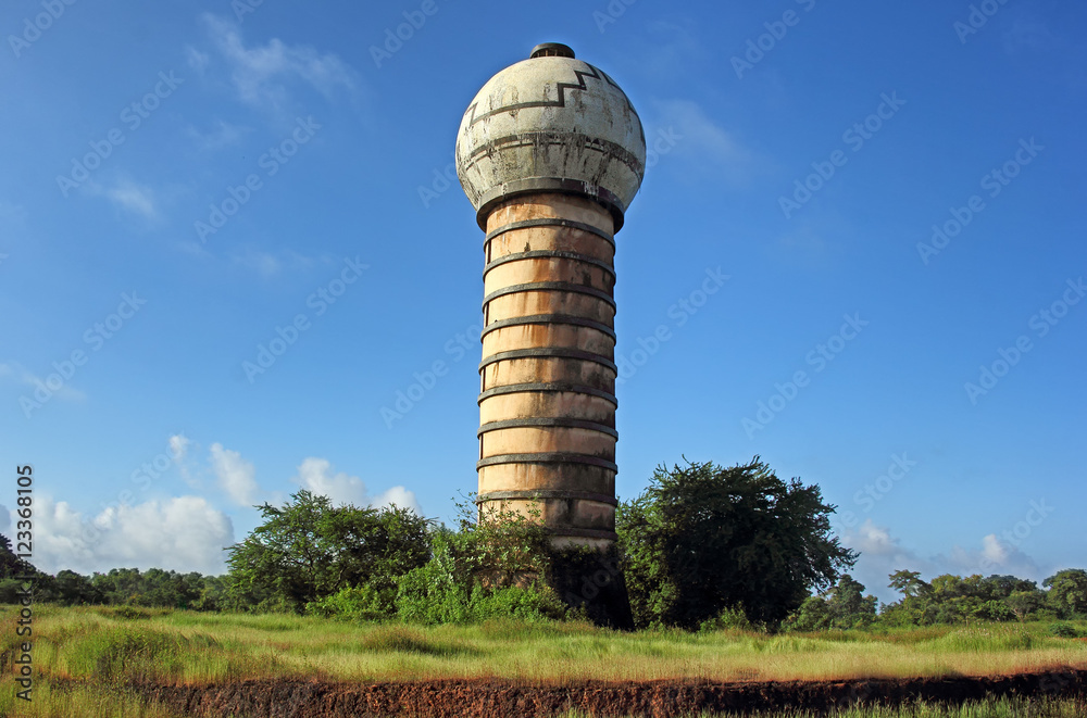 Old style bulb-shaped overhead water tank in countryside