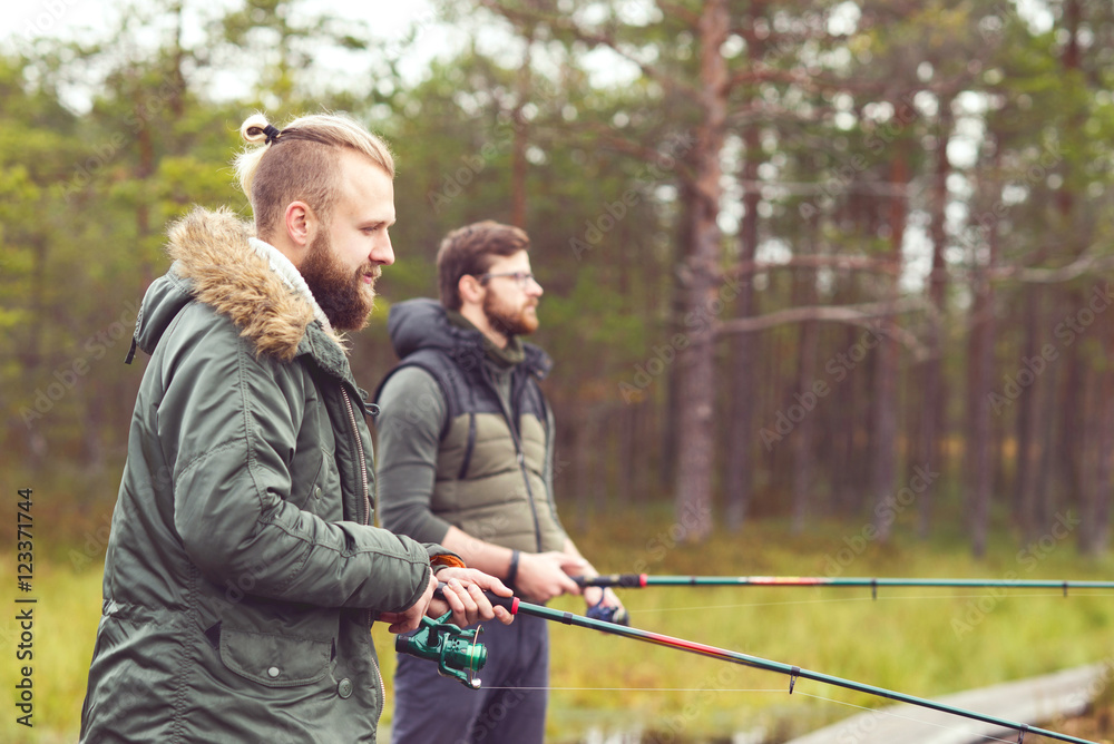 Fishermen with a spinning rod catching fish on a river