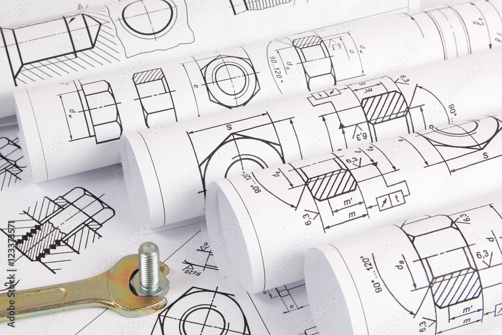 Wrench and bolt on background of engineering drawings. Science, mechanics and mechanical engineering Wrench and bolt on background of engineering drawings. Science, mechanics and mechanical engineering
