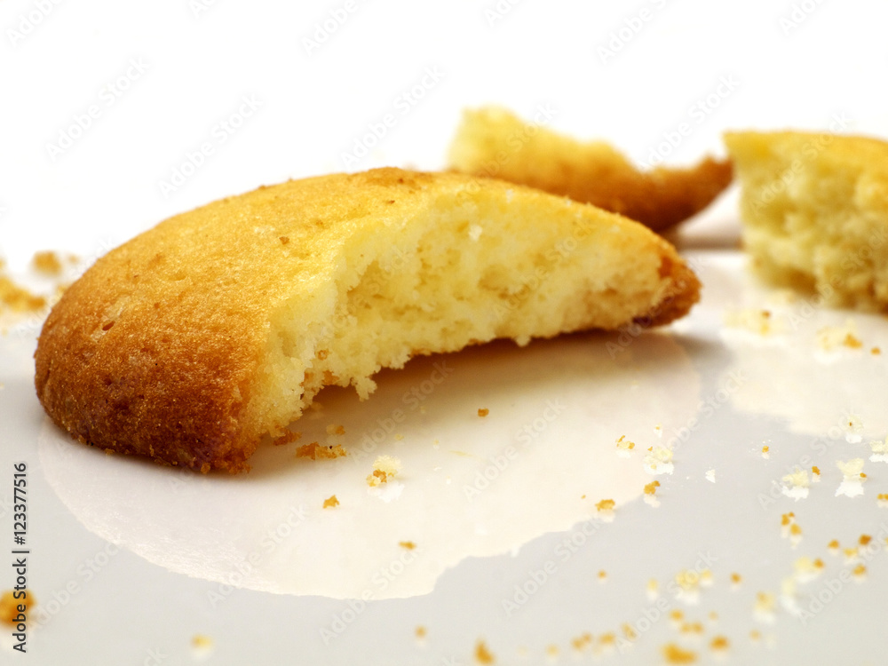closeup of broken cookie on white plate, shallow depth of field closeup of broken cookie on white plate, shallow depth of field