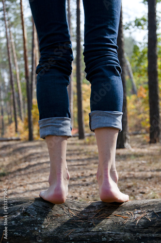 barefoot legs jumping in forest