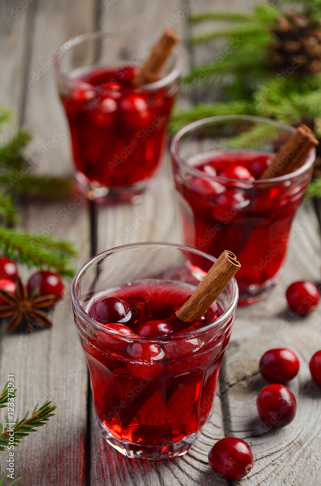 Cranberry drink on wooden background with fir branches and fresh berries, selective focus Cranberry drink on wooden background with fir branches and fresh berries, selective focus