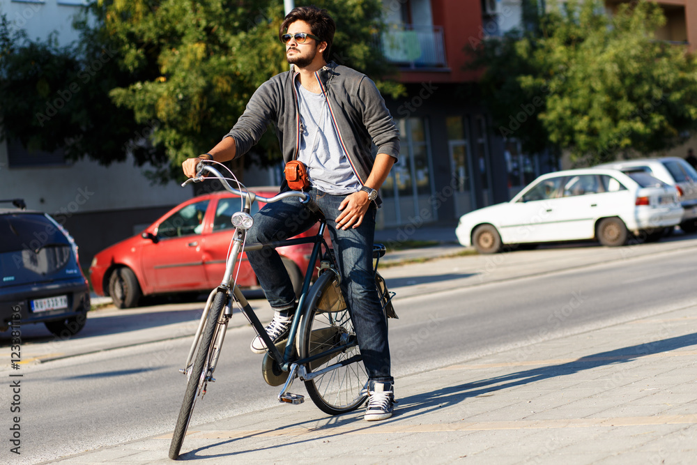 Young handsome guy with a bicycle on street. Young handsome guy with a bicycle on street.