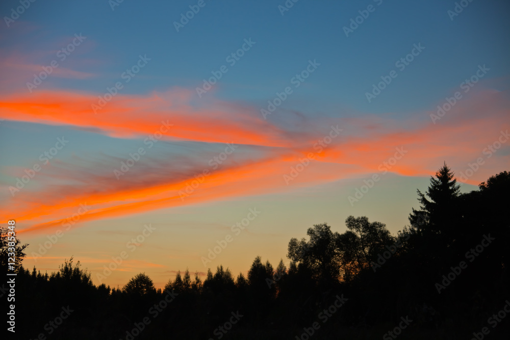 Clouds at sunrise colored sun rays