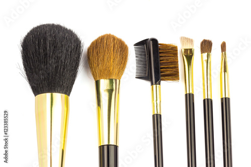 Professional cosmetic brushes for makeup on white background.