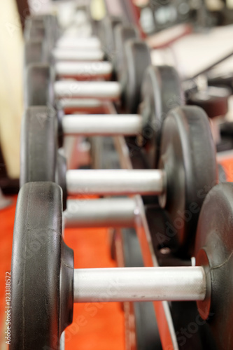 The image of dumbbells on a stand