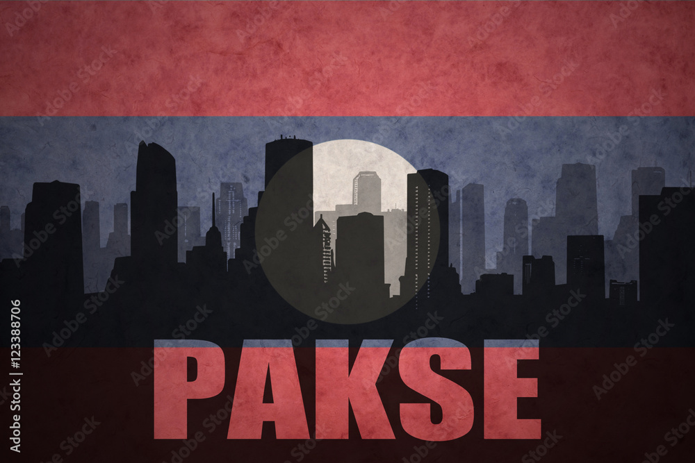 abstract silhouette of the city with text Pakse at the vintage laotian flag background