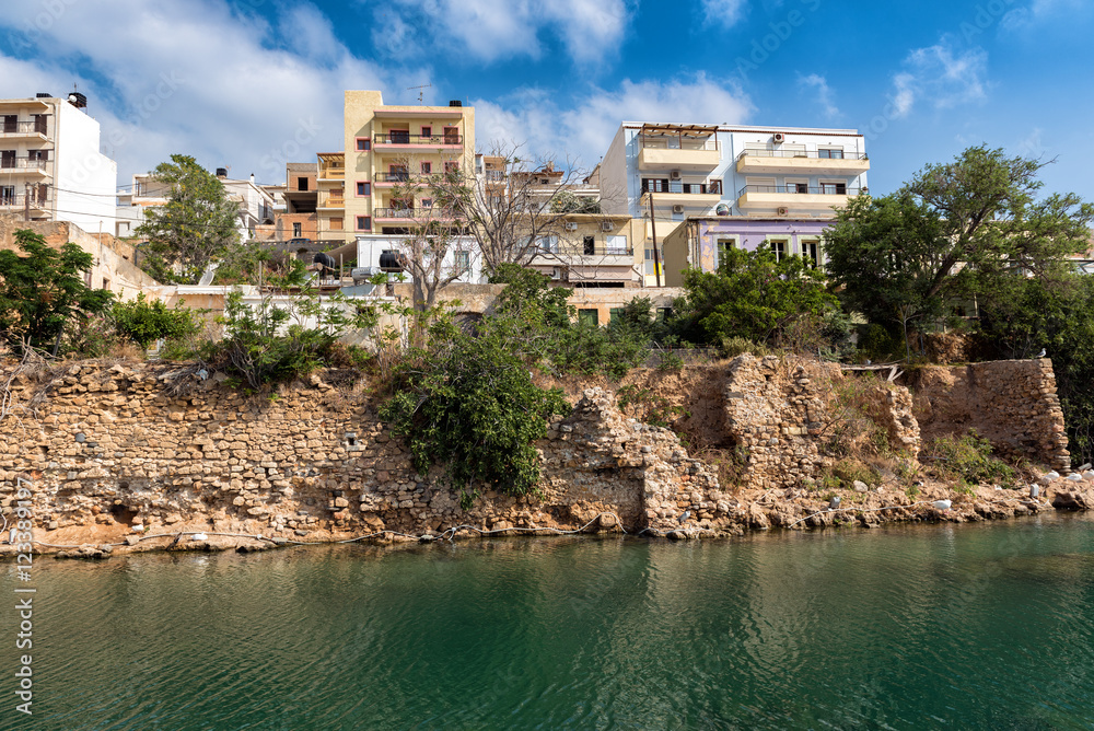 Greek houses on cliff of river channel at Sitia town on Crete island