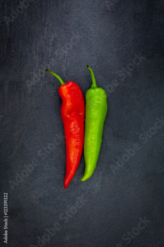 Red and green peper on a gray slate