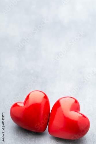 Red heart on the gray metal background.