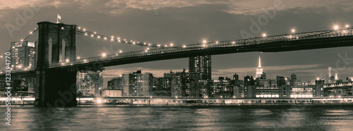 Vintage image of the Brooklyn Bridge illuminated at night