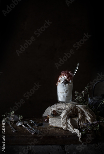 Vanilla ice Cream Cup with Caramel and Chocolate on Dark Background
