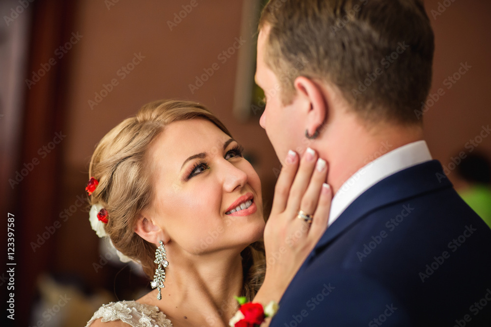 Beautiful bride with expressive eyes looking at the groom during their first meeting at a wedding ceremony Beautiful bride with expressive eyes looking at the groom during their first meeting at a wedding ceremony