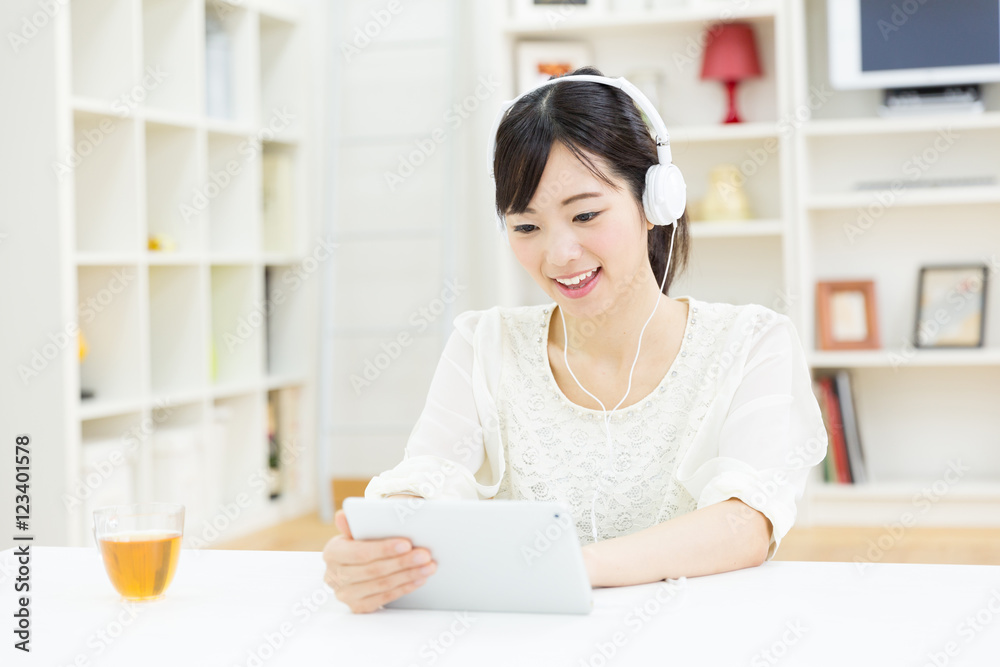 attractive asian woman using tablet computer attractive asian woman using tablet computer