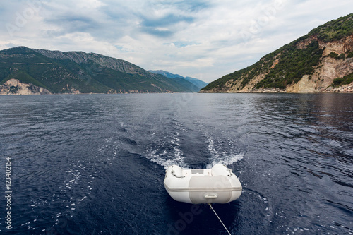 Dinghy boat being towed by a larger boat, Ionian Sea, Greece