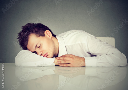 Man sleeping on a desk office table