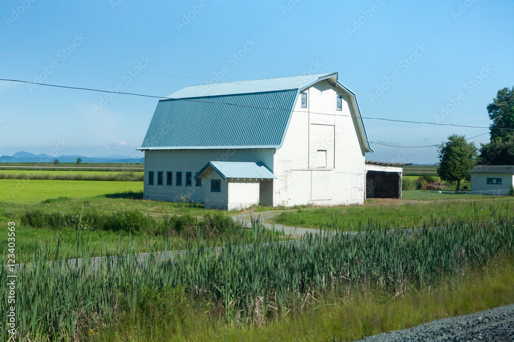 Blue tin roofed barn on prairie Blue tin roofed barn on prairie