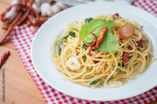 Spicy spaghetti with sausage, basil and chilli
