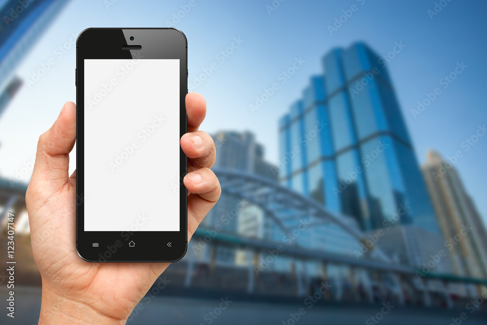 Hand holding blank screen smart phone with office buiding backgr Hand holding blank screen smart phone with office buiding backgr