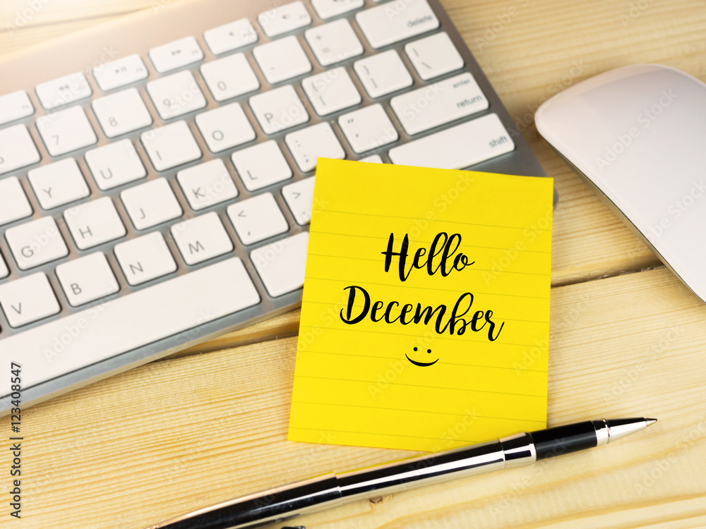Hello December on sticky note on work table Hello December on sticky note on work table